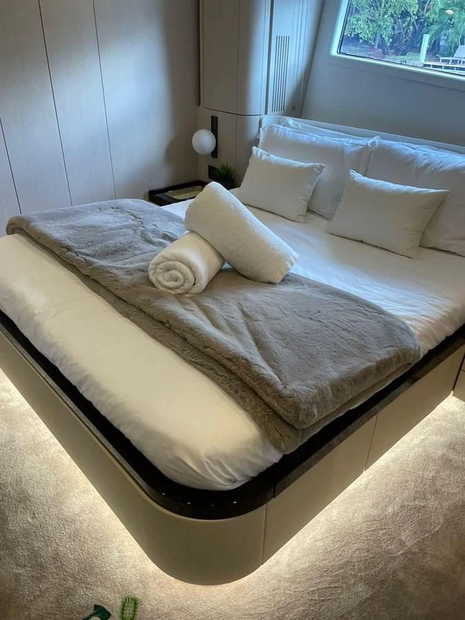 a bed with white sheets aboard SUN LIFE Yacht for Sale