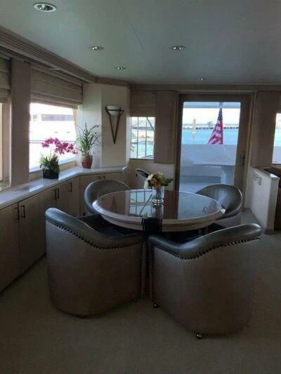 a kitchen with a table and chairs aboard LADY GRACE Yacht for Sale