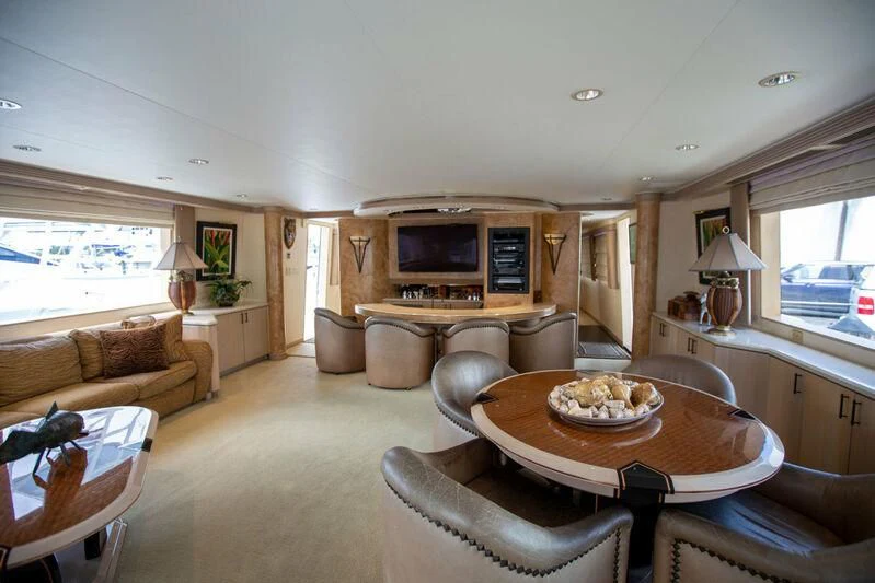 a living room with a table and chairs aboard LADY GRACE Yacht for Sale