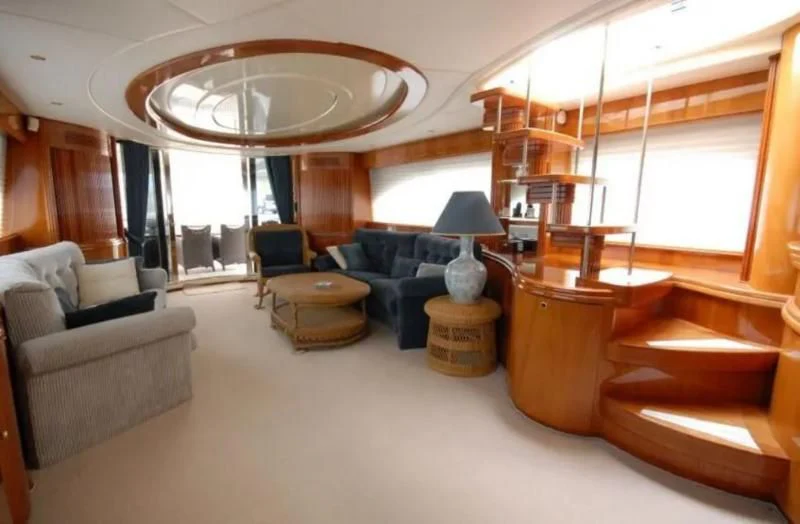 a large living room with a large window aboard STOLI Yacht for Sale