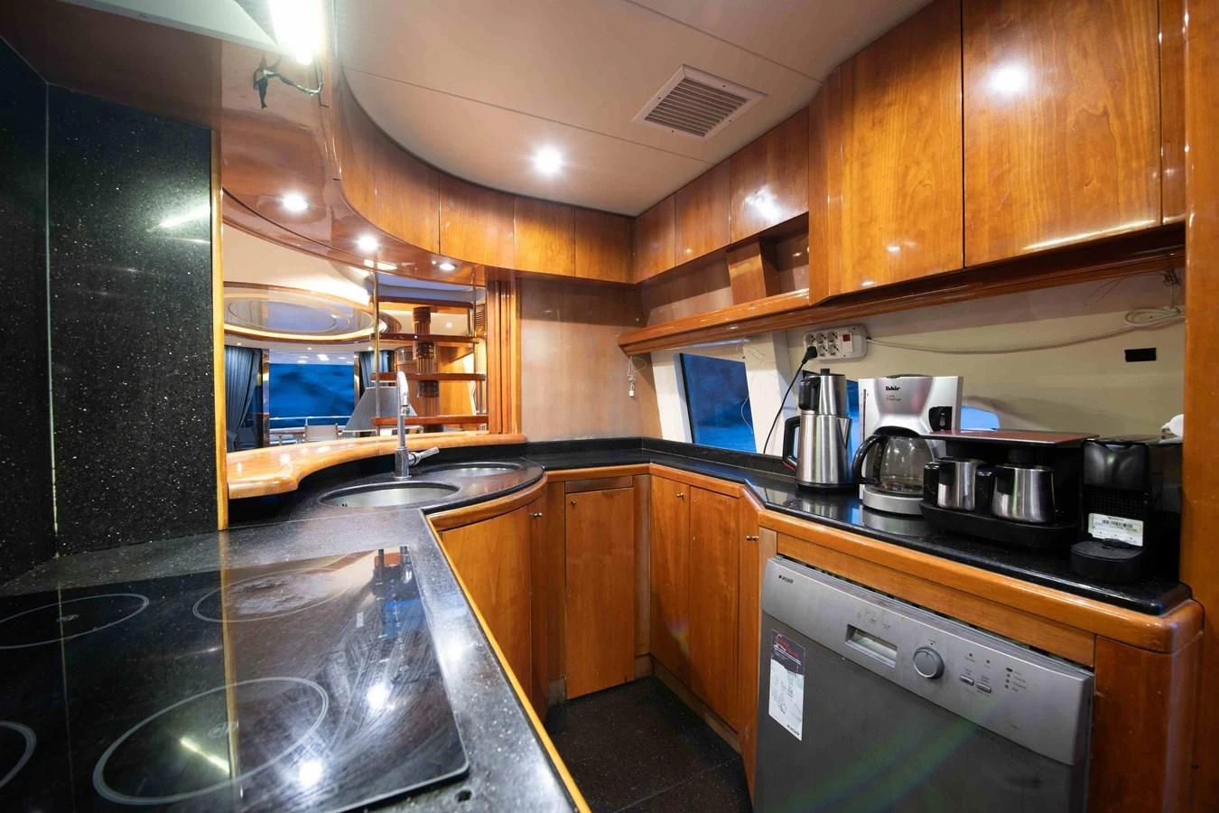 a kitchen with wooden cabinets aboard STOLI Yacht for Sale