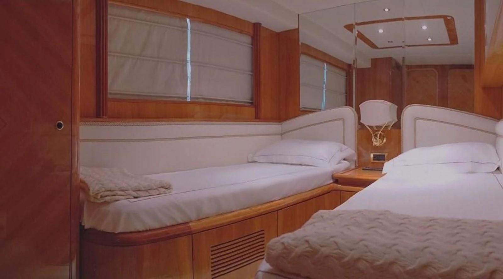 a room with three beds aboard STOLI Yacht for Sale