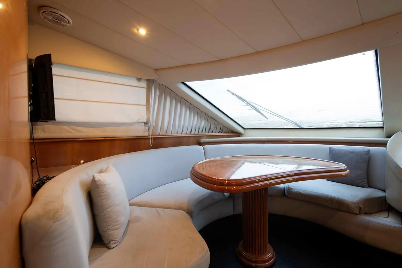 a living room with a table and couch aboard STOLI Yacht for Sale