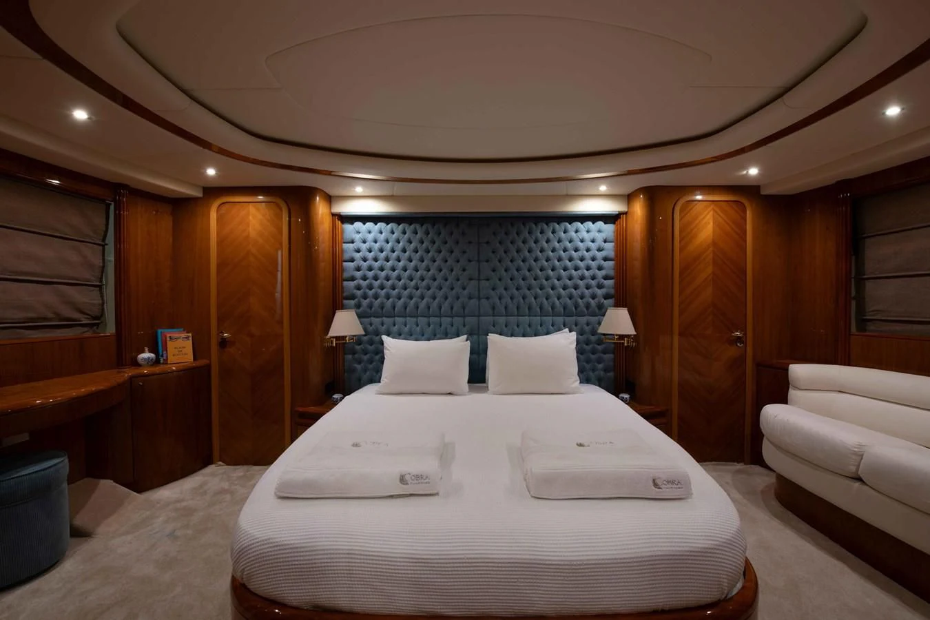 a room with a bed and a couch aboard STOLI Yacht for Sale