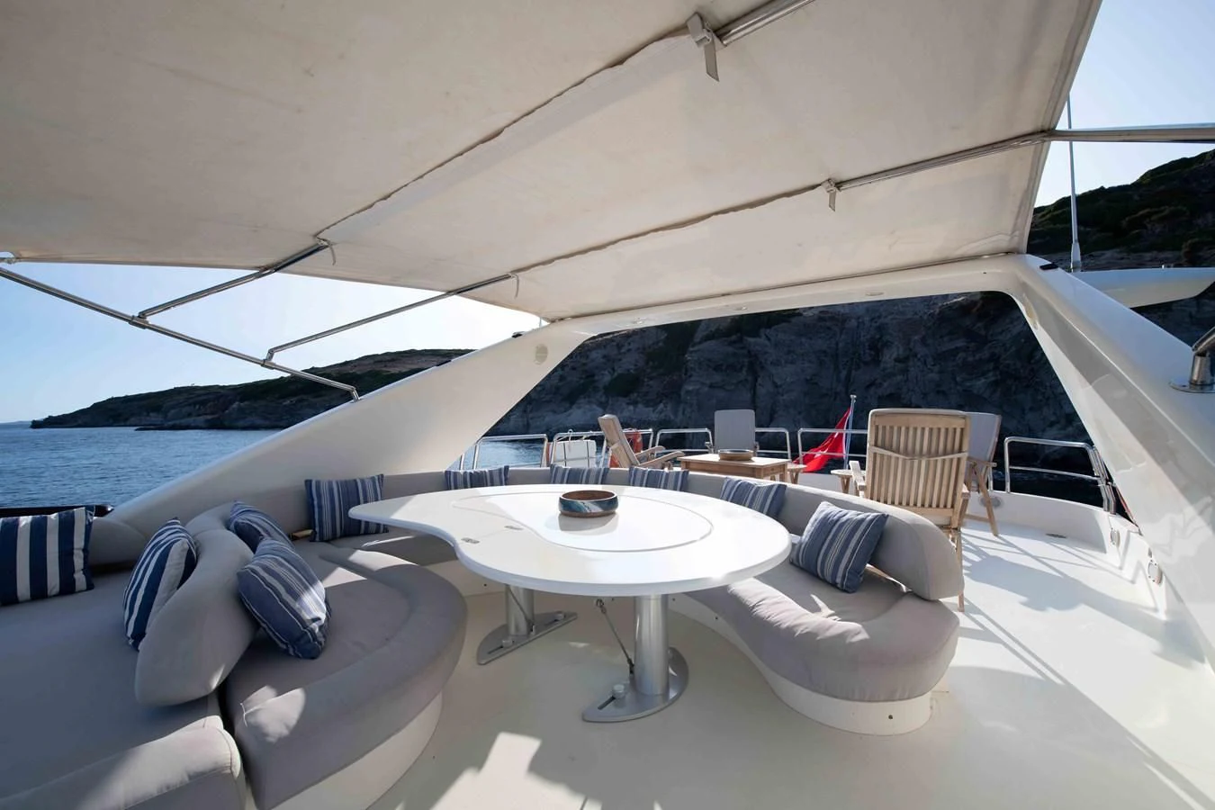 a table and chairs on a boat aboard STOLI Yacht for Sale