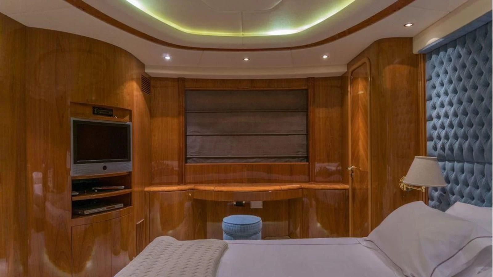 a bed and a television in a room aboard STOLI Yacht for Sale