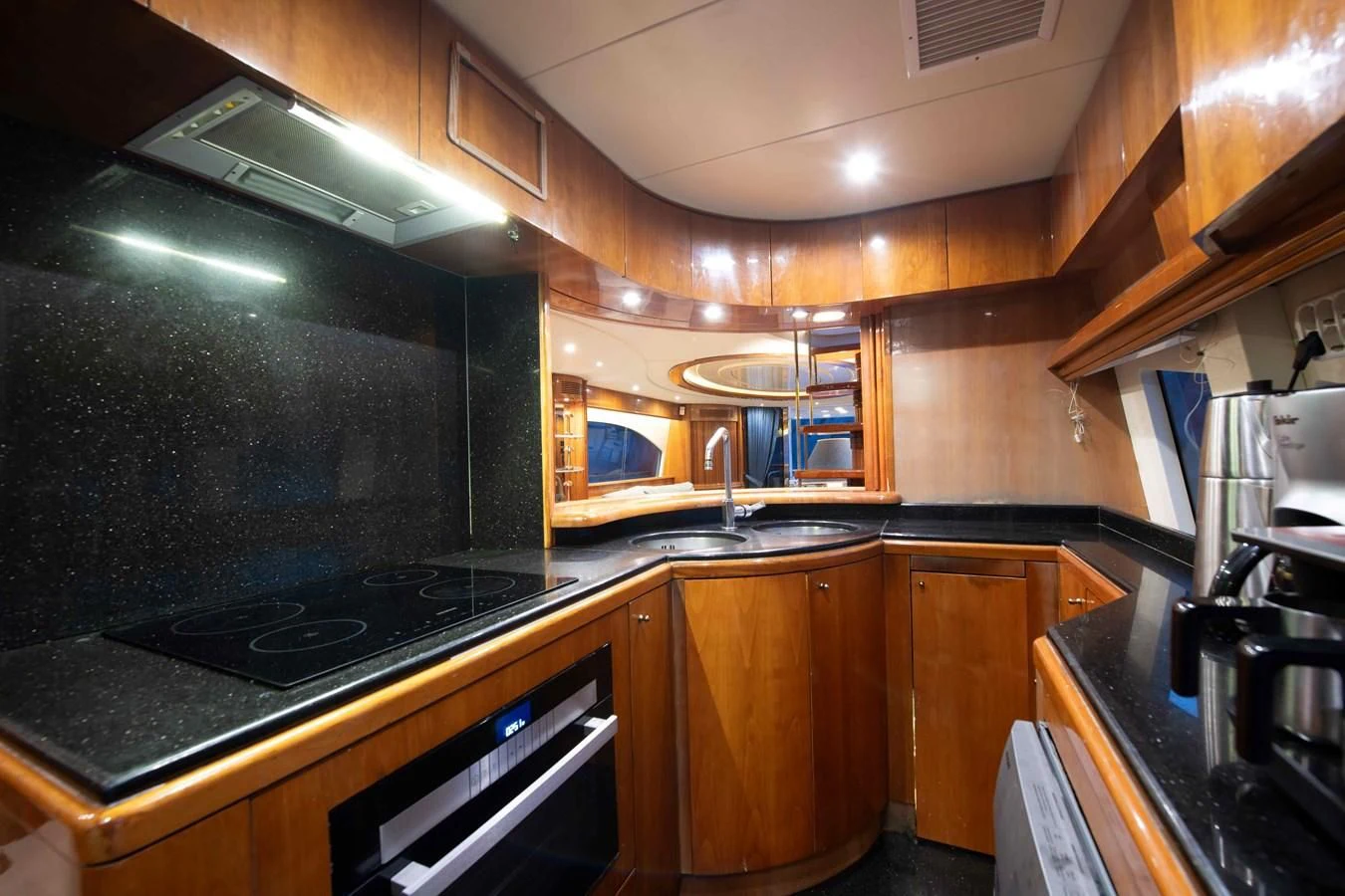 a kitchen with wooden cabinets aboard STOLI Yacht for Sale