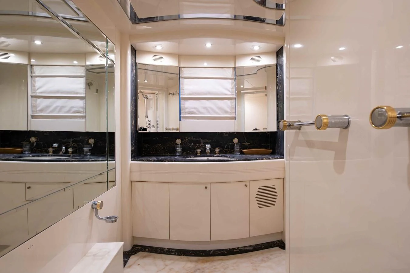 a bathroom with a sink and a mirror aboard STOLI Yacht for Sale