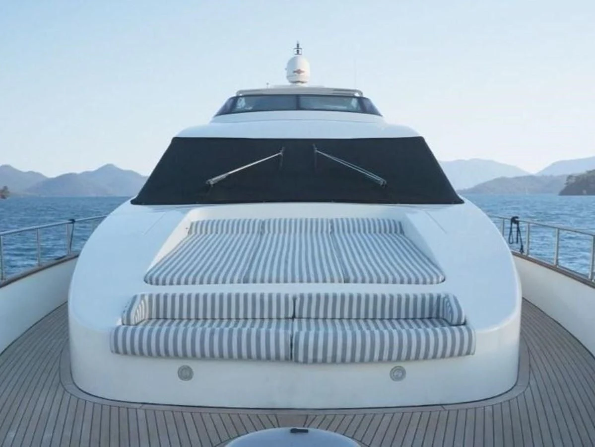 a white and black boat on a dock aboard STOLI Yacht for Sale