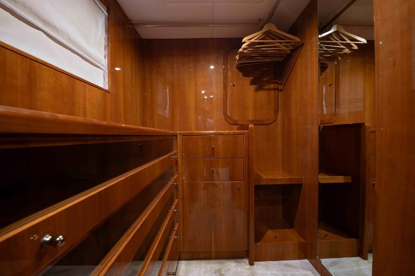 a wooden room with wooden cabinets aboard STOLI Yacht for Sale