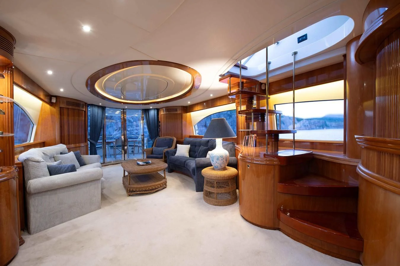 a living room with a large chandelier aboard STOLI Yacht for Sale