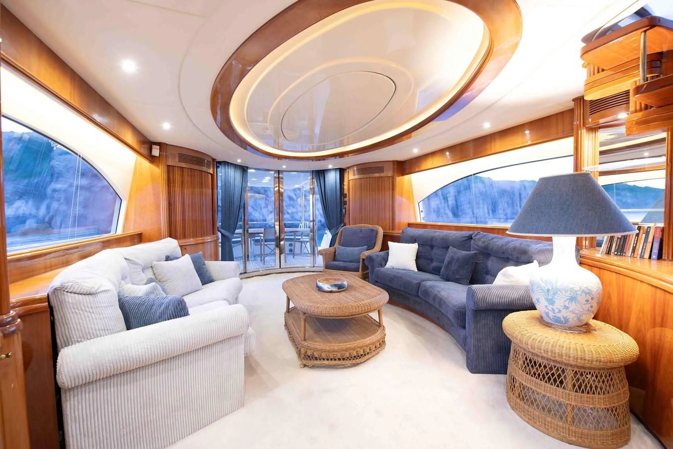 a living room with a large chandelier aboard STOLI Yacht for Sale