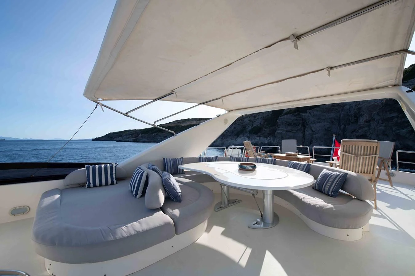 a large white tent with a table and chairs aboard STOLI Yacht for Sale