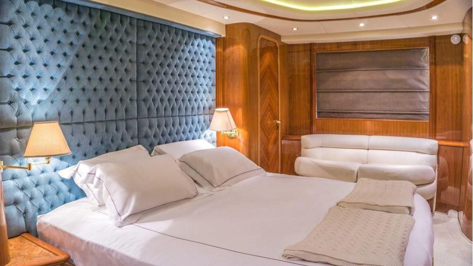 a room with a bed and a desk aboard STOLI Yacht for Sale