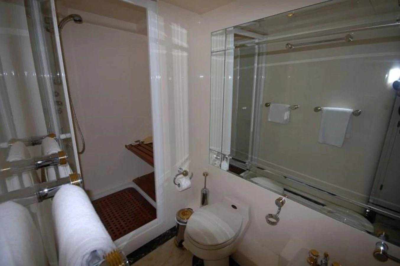 a bathroom with a glass shower aboard STOLI Yacht for Sale