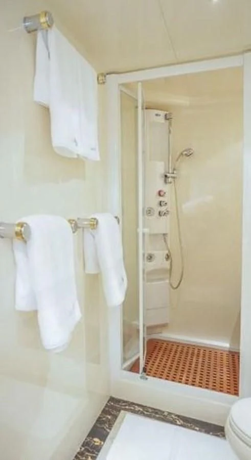 a bathroom with a shower and a sink aboard STOLI Yacht for Sale