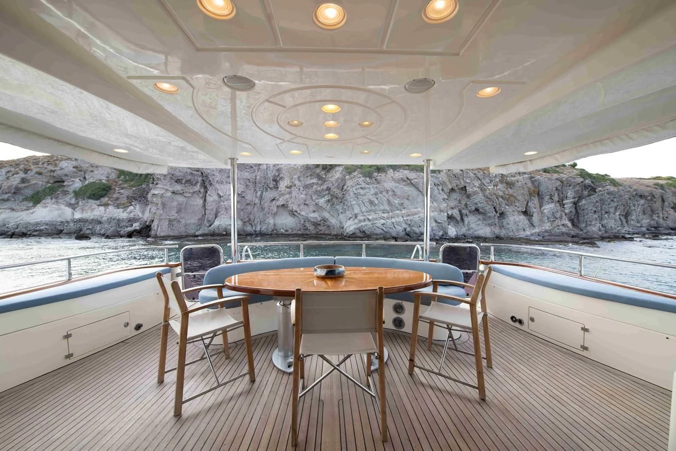 a table and chairs in a room aboard STOLI Yacht for Sale