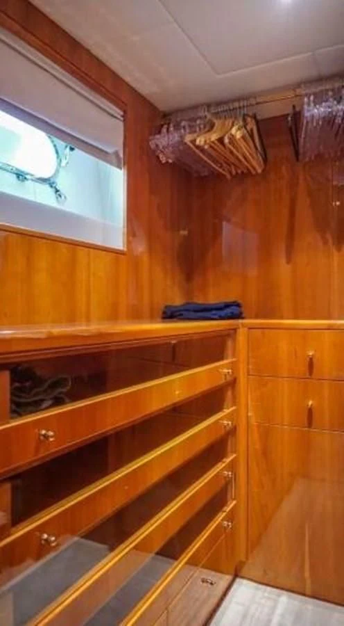 a kitchen with wooden cabinets aboard STOLI Yacht for Sale