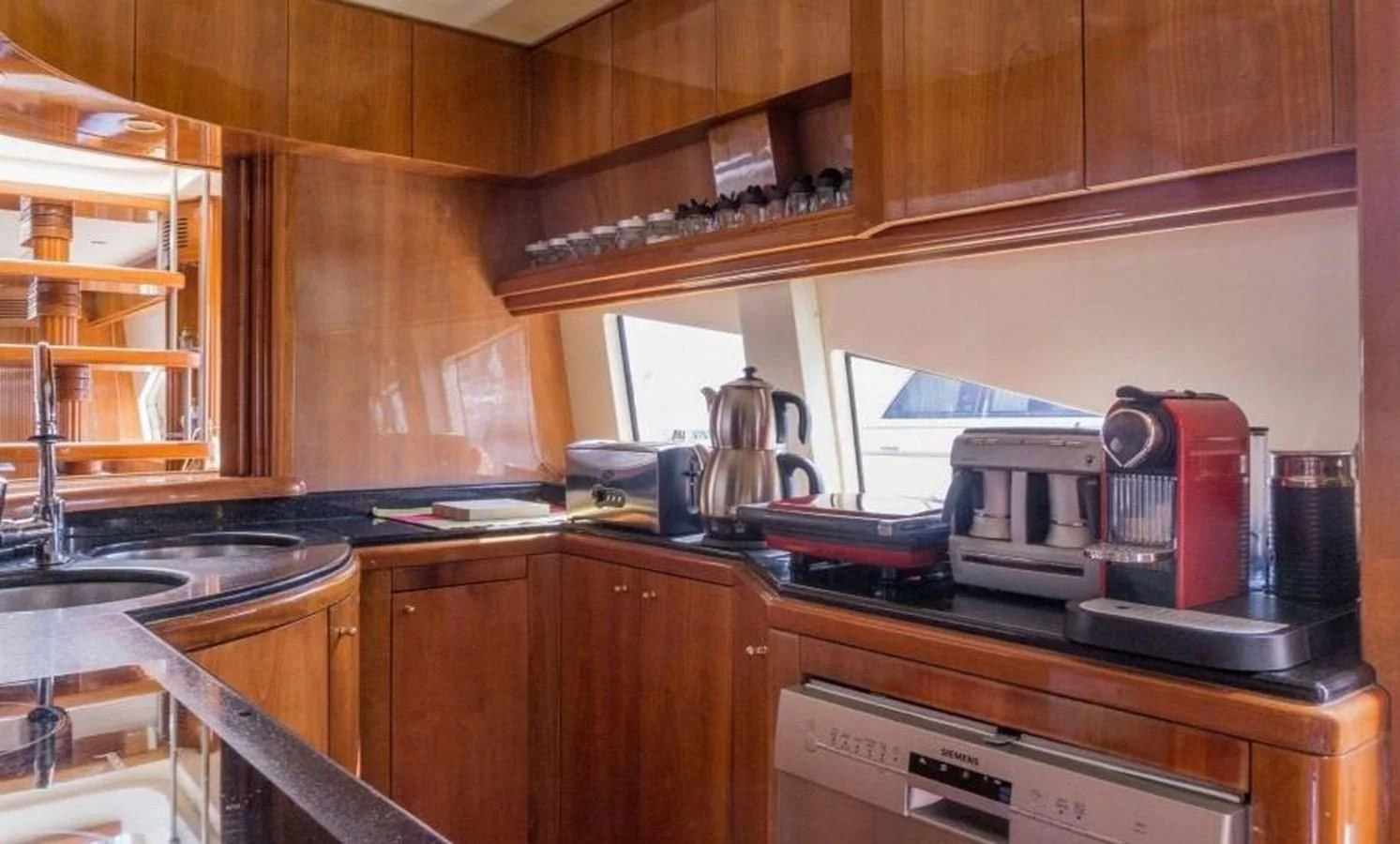 a kitchen with a coffee maker aboard STOLI Yacht for Sale