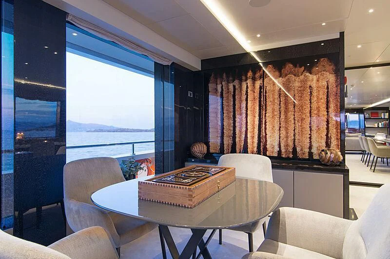 a room with a table and chairs aboard MY EDEN Yacht for Sale