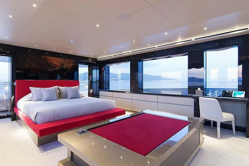 a room with a bed and a table aboard MY EDEN Yacht for Sale