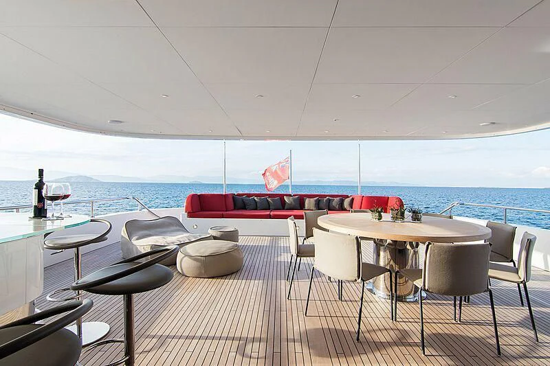 a room with a table and chairs and a view of the water aboard MY EDEN Yacht for Sale