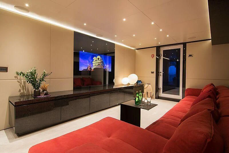a living room with a red couch aboard MY EDEN Yacht for Sale