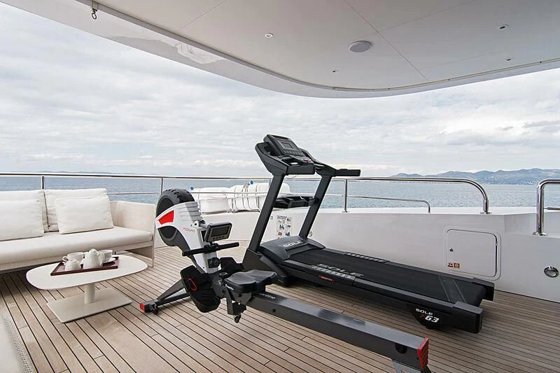 a deck with a pool table and chairs on it aboard MY EDEN Yacht for Sale