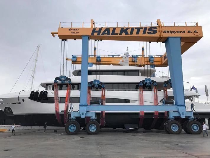 a large crane lifting a container aboard MY EDEN Yacht for Sale