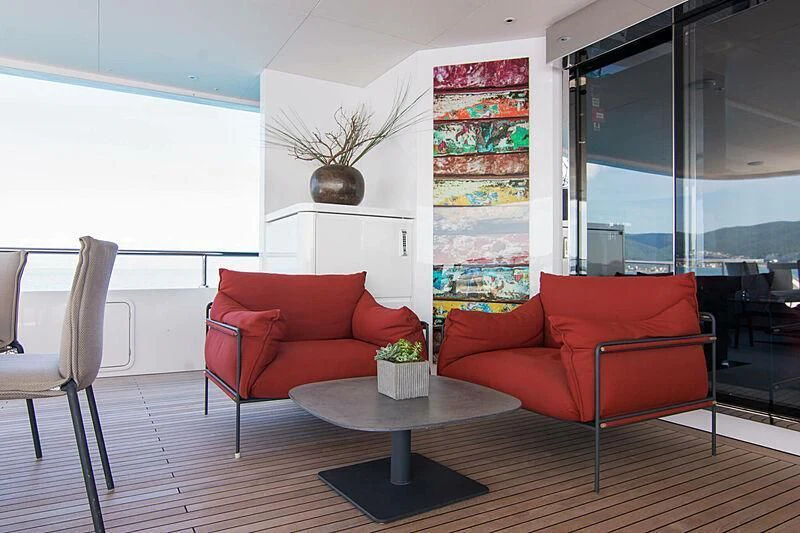 a room with red couches and a coffee table aboard MY EDEN Yacht for Sale