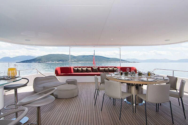 a table and chairs on a deck aboard MY EDEN Yacht for Sale