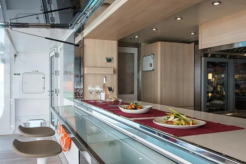 a kitchen with a table and chairs aboard MY EDEN Yacht for Sale