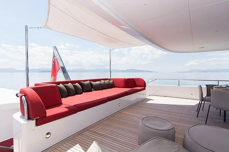 a red couch on a boat aboard MY EDEN Yacht for Sale