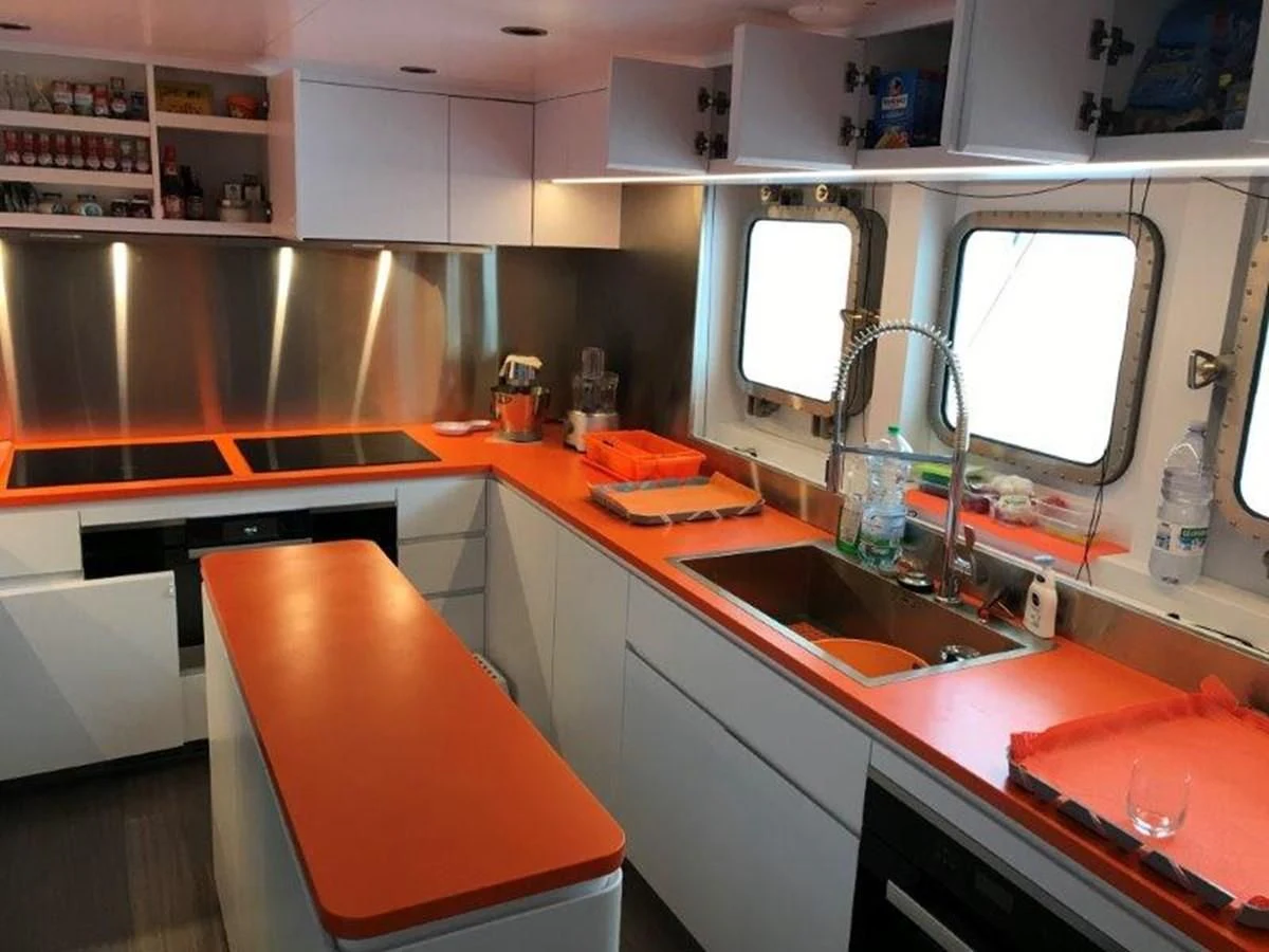 a kitchen with a sink and a window aboard OCEAN KING 130 Yacht for Sale