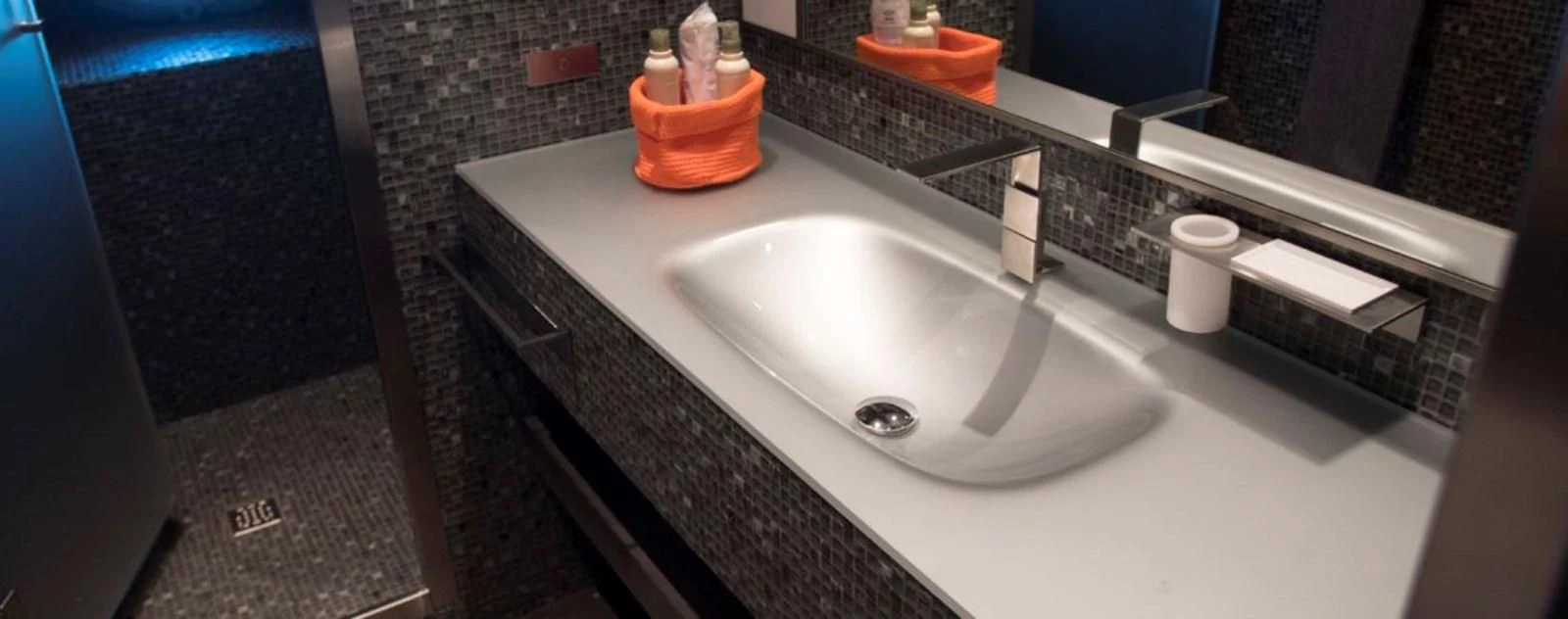 a sink with a mirror above it aboard OCEAN KING 130 Yacht for Sale