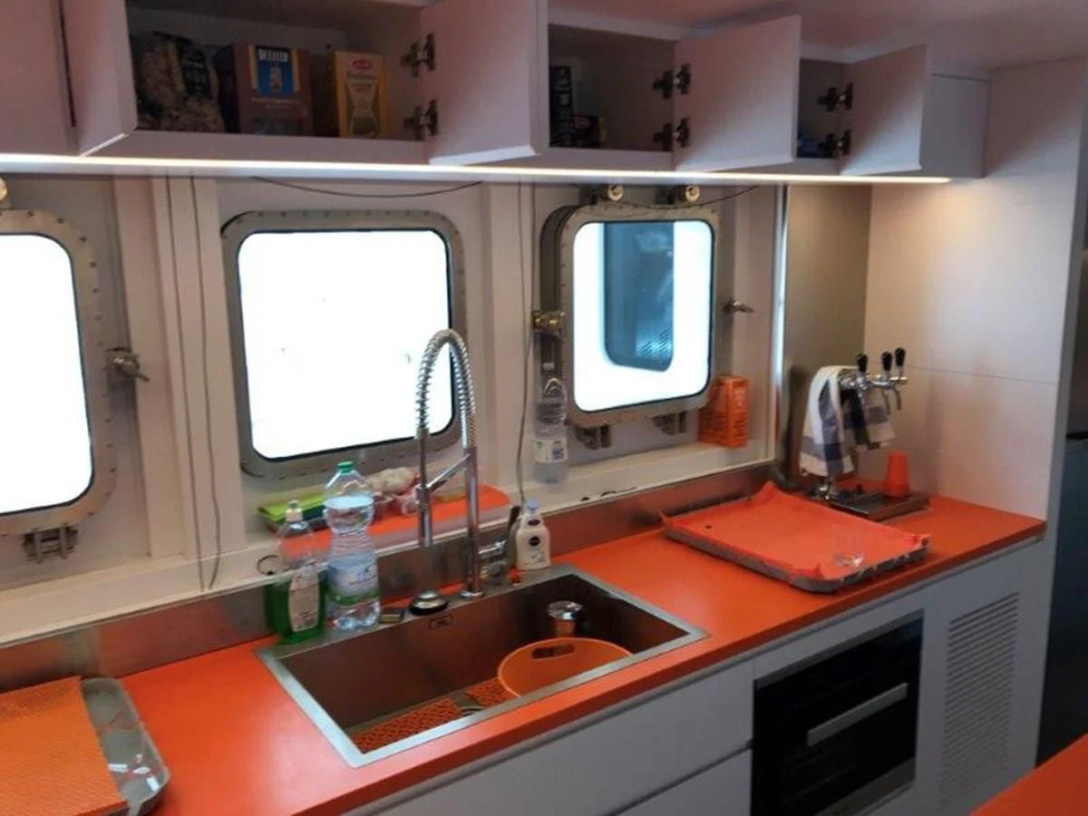 a kitchen with a sink and a mirror aboard OCEAN KING 130 Yacht for Sale