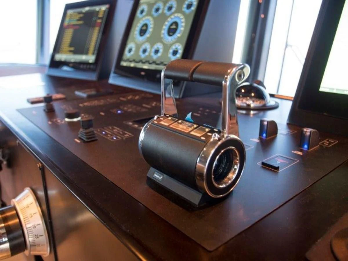 a small wooden machine on a table aboard OCEAN KING 130 Yacht for Sale