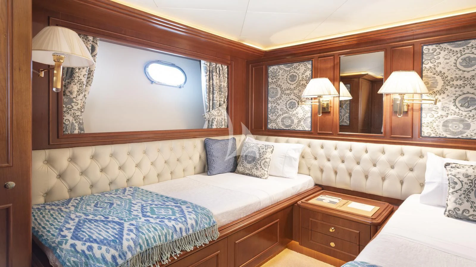a room with a bed and a mirror aboard IMAGINE Yacht for Charter
