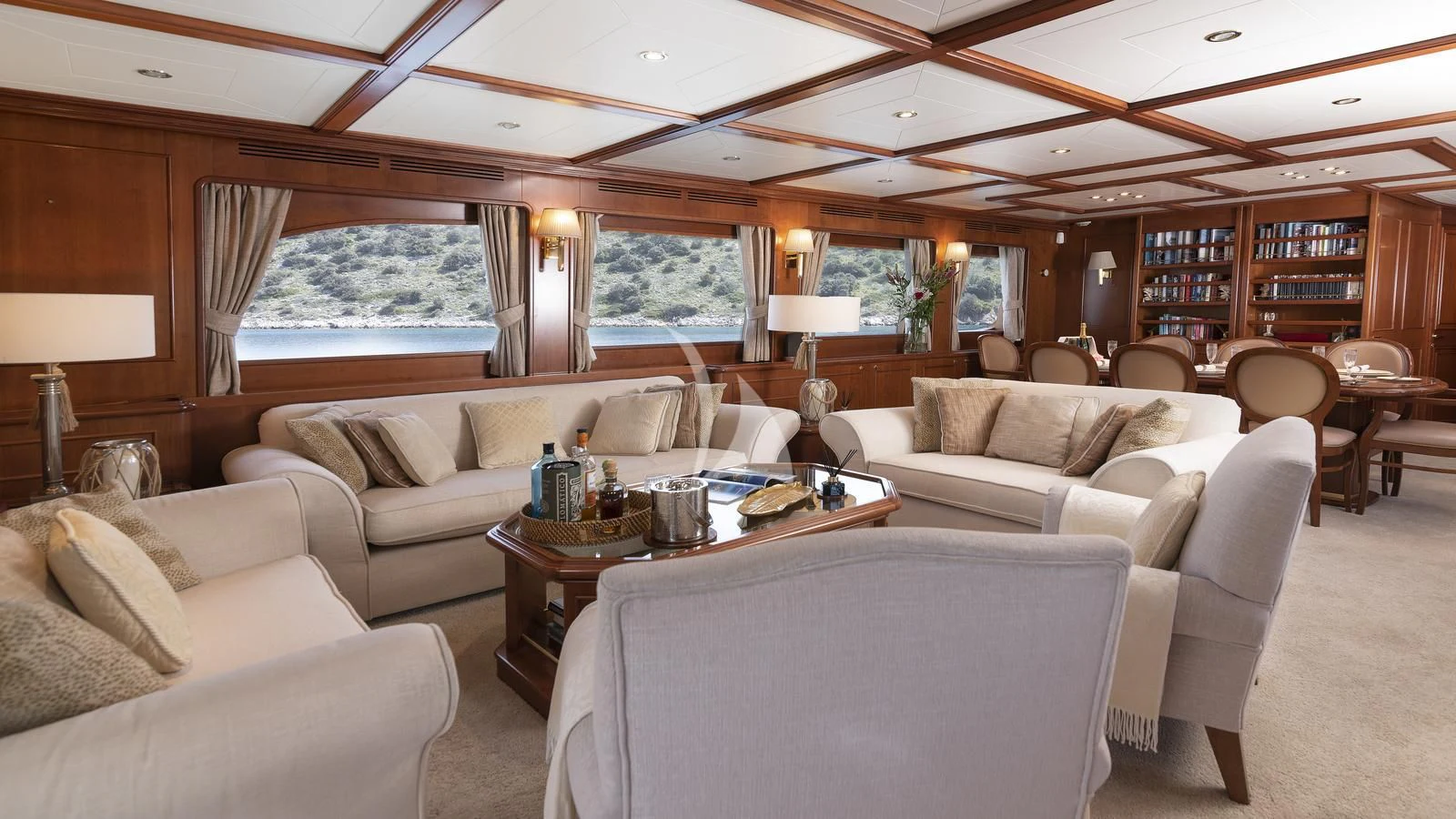 a living room with a large window aboard IMAGINE Yacht for Charter