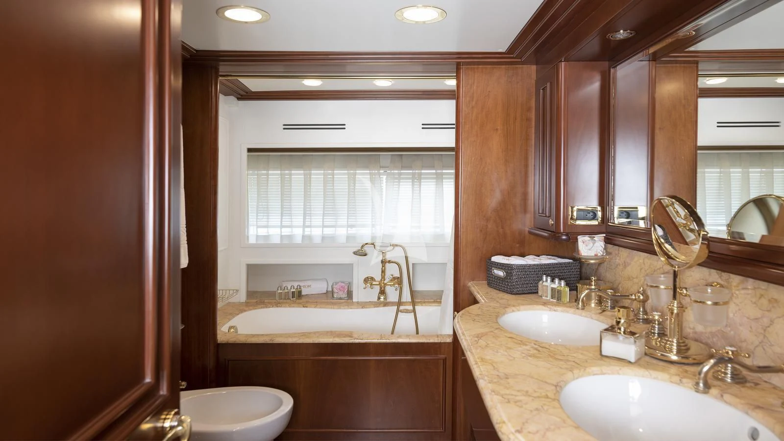 a bathroom with a tub sink and sink aboard IMAGINE Yacht for Charter