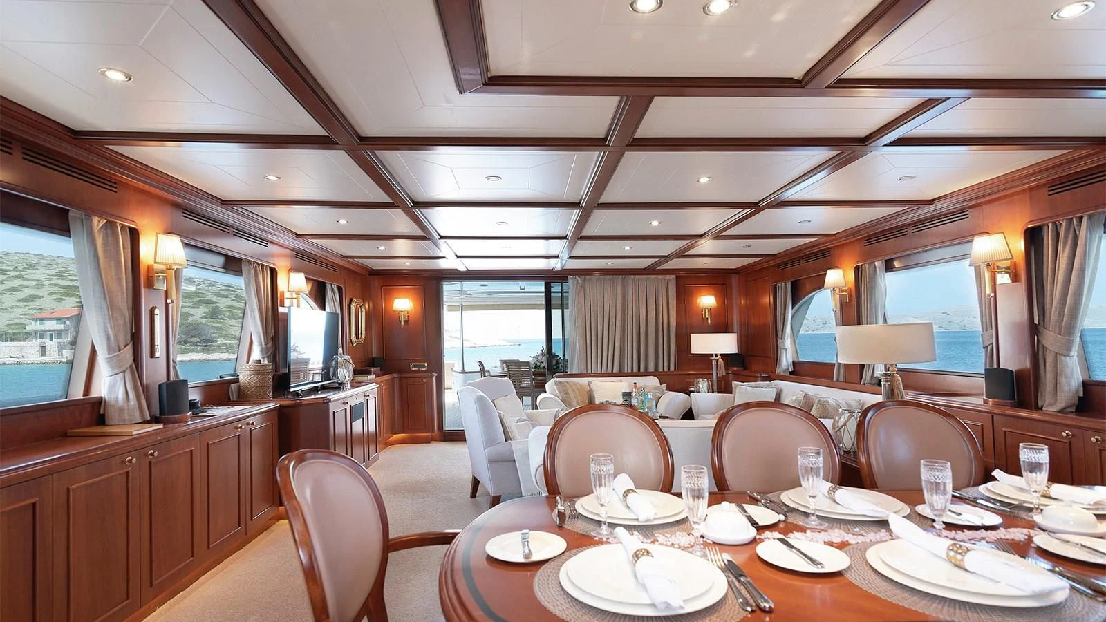 a large room with tables and chairs aboard IMAGINE Yacht for Charter