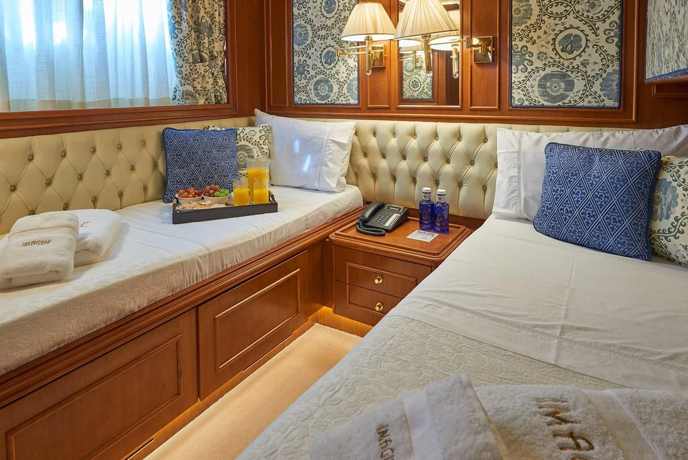 a hotel room with two beds aboard IMAGINE Yacht for Charter