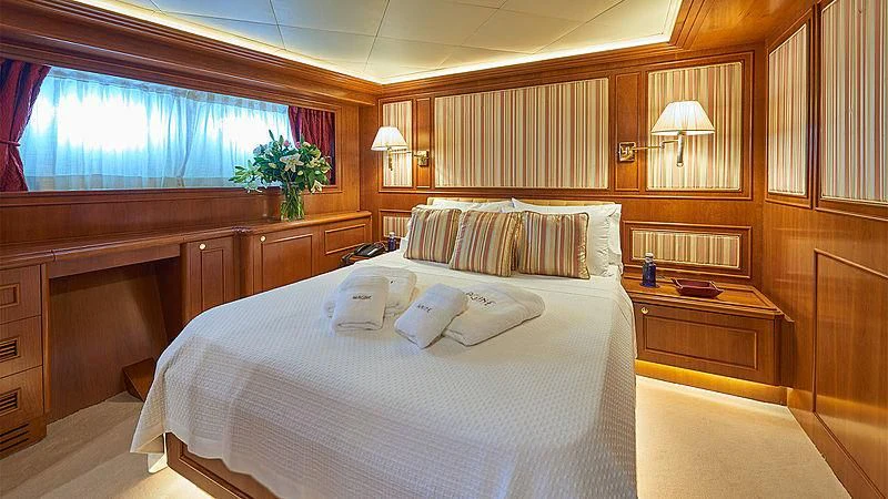 a room with a bed and a window aboard IMAGINE Yacht for Charter