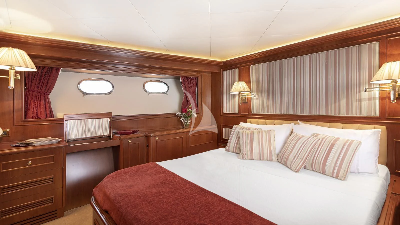 a hotel room with a bed and desk aboard IMAGINE Yacht for Charter