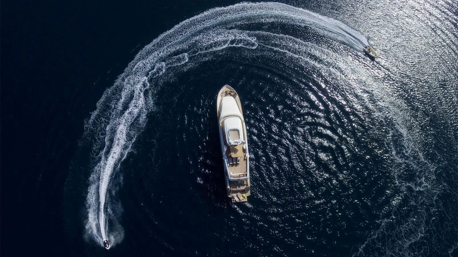 a silver and gold watch on a blue surface aboard IMAGINE Yacht for Charter