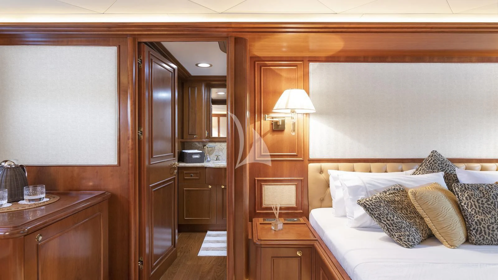 a bedroom with a bed and a desk aboard IMAGINE Yacht for Charter