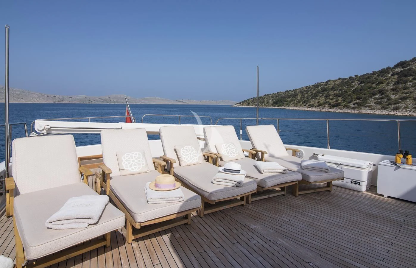 a group of chairs on a deck overlooking a body of water aboard IMAGINE Yacht for Charter