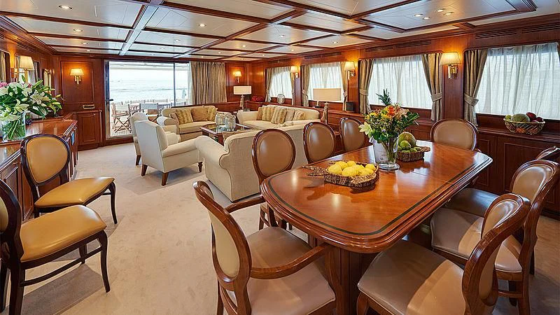 a large dining room with a large table and chairs aboard IMAGINE Yacht for Charter