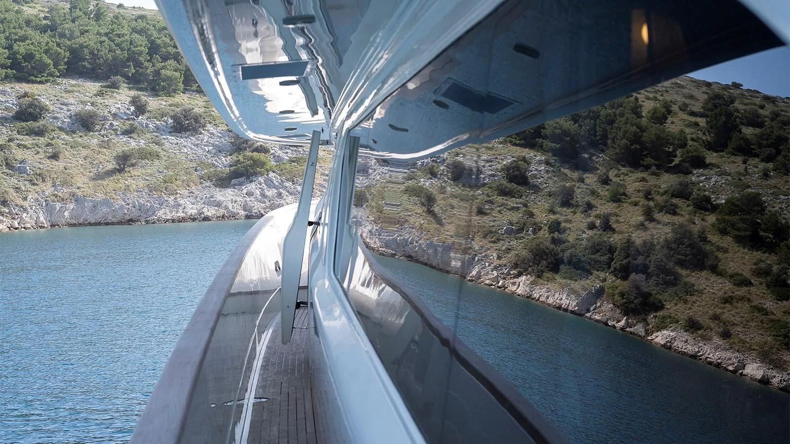 a long road with a bridge over water aboard IMAGINE Yacht for Charter