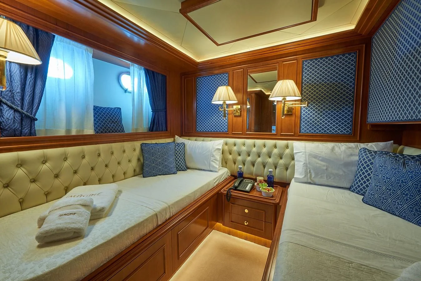 a room with two beds aboard IMAGINE Yacht for Charter